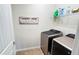 Laundry room with laundry appliances and shelf with laundry supplies. Laundry room sign on the wall at 333 Almansa St, Davenport, FL 33837