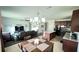 Open-concept living area featuring a dining table, a kitchen island, and a comfortable living room setup at 333 Almansa St, Davenport, FL 33837