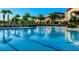 View of the community swimming pool with several beach chairs lined up on the deck at 333 Almansa St, Davenport, FL 33837
