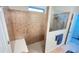 Shower with brown textured tile and built in bench next to blue bath towel. Frameless glass door at 333 Almansa St, Davenport, FL 33837