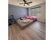 Well-lit bedroom featuring modern decor with a geometric accent wall and stylish window blinds at 377 Holly Berry Dr, Davenport, FL 33897