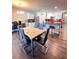 Open dining area with modern marble top table, stylish chairs, and access to a modern kitchen at 377 Holly Berry Dr, Davenport, FL 33897