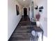 Inviting hallway with dark wood-look floors, white walls and trim, and arched doorways with decorative accents at 377 Holly Berry Dr, Davenport, FL 33897