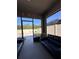 Enclosed patio area with tile flooring, black leather seating, and backyard views at 377 Holly Berry Dr, Davenport, FL 33897