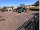 Community playground area featuring slides and play structures with wood chip ground covering at 377 Holly Berry Dr, Davenport, FL 33897