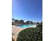 Community pool with pergola, landscaping, lounge chairs, and clear blue skies at 377 Holly Berry Dr, Davenport, FL 33897
