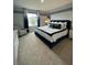 Primary bedroom features a large window, soft carpet, and modern decor at 4247 Shackelford Ct, Orlando, FL 32824