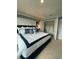 Primary bedroom features a large window, soft carpet, and a spacious closet at 4247 Shackelford Ct, Orlando, FL 32824