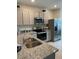 Kitchen featuring granite countertops, stainless appliances, and light gray cabinetry at 4247 Shackelford Ct, Orlando, FL 32824