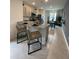 Eat-in kitchen with granite countertops, stainless appliances, tile floors, and view to dining area at 4247 Shackelford Ct, Orlando, FL 32824