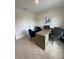 Home office featuring a modern desk, blue accent chairs, and neutral colored walls at 4247 Shackelford Ct, Orlando, FL 32824