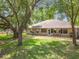 Expansive backyard with mature trees, lawn, and patio perfect for relaxing and entertaining at 4907 Raylene Way, St Cloud, FL 34771