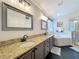 Bright primary bathroom features granite counters, double sinks, walk-in shower and separate tub at 4907 Raylene Way, St Cloud, FL 34771