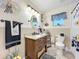 Charming bathroom featuring wainscoting, granite countertop, and stylish black and white accents at 4907 Raylene Way, St Cloud, FL 34771