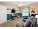 Cozy bedroom featuring two-tone paint, a ceiling fan, a window and comfortable seating at 4907 Raylene Way, St Cloud, FL 34771
