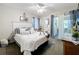 Inviting bedroom with a plush bed, decorative pillows, and a view into the ensuite bathroom at 4907 Raylene Way, St Cloud, FL 34771