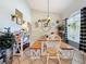 Charming dining room showcasing farmhouse-style decor, a rustic wooden table, and a window with natural light at 4907 Raylene Way, St Cloud, FL 34771