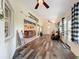 Inviting sunroom featuring stylish wood-look floors and multiple windows with backyard views at 4907 Raylene Way, St Cloud, FL 34771