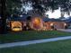 Charming home with landscaped front yard, beautiful illumination, and welcoming front porch at 4907 Raylene Way, St Cloud, FL 34771