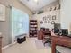 Classic home office with a dark wood desk, bookshelf, and comfortable seating, perfect for productivity at 4907 Raylene Way, St Cloud, FL 34771