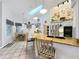 Open kitchen with island seating, modern appliances, and an abundance of natural light at 4907 Raylene Way, St Cloud, FL 34771
