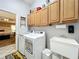 Functional laundry room with modern washer, dryer, sink, and ample cabinet space at 4907 Raylene Way, St Cloud, FL 34771