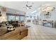 Comfortable living room with a large sectional sofa, windows, and tiled floors at 4907 Raylene Way, St Cloud, FL 34771