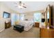 Bright main bedroom features carpet, a ceiling fan, windows and coordinating furniture at 4907 Raylene Way, St Cloud, FL 34771