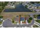 Aerial view of property featuring a lake, lawn, and pool with neighboring houses in a cul-de-sac at 4910 Culdesac Ct St, St Cloud, FL 34772