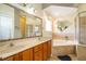 Bright bathroom featuring double sinks, soaking tub and glass shower enclosure at 4910 Culdesac Ct St, St Cloud, FL 34772