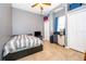 This is a cozy bedroom with a bed, a ceiling fan and a gray wall. Also there is a TV and a closet at 4910 Culdesac Ct St, St Cloud, FL 34772