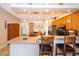 The kitchen flows to the living room with a large countertop, wooden cabinets and stools at 4910 Culdesac Ct St, St Cloud, FL 34772
