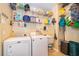 Laundry room with a washer, dryer, shelves full of detergent and supplies, and a utility sink at 4910 Culdesac Ct St, St Cloud, FL 34772