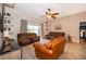 Comfortable living room featuring tile floors, ceiling fan, and a sliding glass doors to the backyard at 4910 Culdesac Ct St, St Cloud, FL 34772