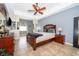 Main bedroom featuring a ceiling fan, tiled floors, and ensuite bathroom at 4910 Culdesac Ct St, St Cloud, FL 34772