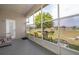 Screened patio with chairs and views of the backyard and lake at 4910 Culdesac Ct St, St Cloud, FL 34772