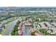Scenic aerial view of the homes next to the lake, community pool, and greenery in a suburban neighborhood with views of Universal Studios at 5316 Burning Tree Dr # A09-2, Orlando, FL 32811