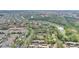 Overhead view of condos and homes next to the lake, surrounded by lush greenery with the highway in the background at 5316 Burning Tree Dr # A09-2, Orlando, FL 32811
