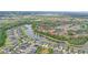 Picturesque aerial view of the homes bordering the lake surrounded by lush trees and greenery in a peaceful neighborhood at 5316 Burning Tree Dr # A09-2, Orlando, FL 32811
