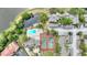 Aerial view of community amenities: swimming pool, tennis courts, residential buildings, and a serene pond at 5316 Burning Tree Dr # A09-2, Orlando, FL 32811