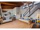 Bright living space with an open floor plan, exposed beams, and staircase to the upper level at 5316 Burning Tree Dr # A09-2, Orlando, FL 32811