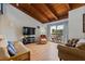 Inviting living room with a wooden ceiling, balcony, and comfortable seating area featuring lots of light at 5316 Burning Tree Dr # A09-2, Orlando, FL 32811