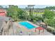 Community pool with sundeck surrounded by lush landscaping and community clubhouse at 5316 Burning Tree Dr # A09-2, Orlando, FL 32811