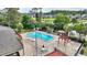 Beautiful community pool area with lounge chairs, tables, and landscaping overlooking the neighborhood at 5316 Burning Tree Dr # A09-2, Orlando, FL 32811