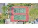 Overhead view of community tennis courts showcasing green and red surface and perimeter landscaping at 5316 Burning Tree Dr # A09-2, Orlando, FL 32811