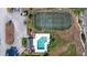 Aerial view showcasing the pool, tennis court, and parking area within the community at 5524 Loma Vista, Davenport, FL 33896