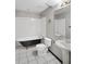 Bathroom featuring a standalone tub, tiled floors, toilet and pedestal sink at 5524 Loma Vista, Davenport, FL 33896