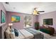Relaxing bedroom with wall decor and outdoor views through a bright window at 5524 Loma Vista, Davenport, FL 33896