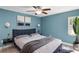 Comfortable bedroom featuring light blue walls, a ceiling fan, and decoratively matching wall art at 5524 Loma Vista, Davenport, FL 33896