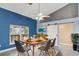 Bright dining room with modern decor, stylish chairs, wood table and sliding barn door to a walk-in pantry at 5524 Loma Vista, Davenport, FL 33896